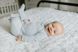 Baby boy smiling in bed Baby boy smiling in bed
